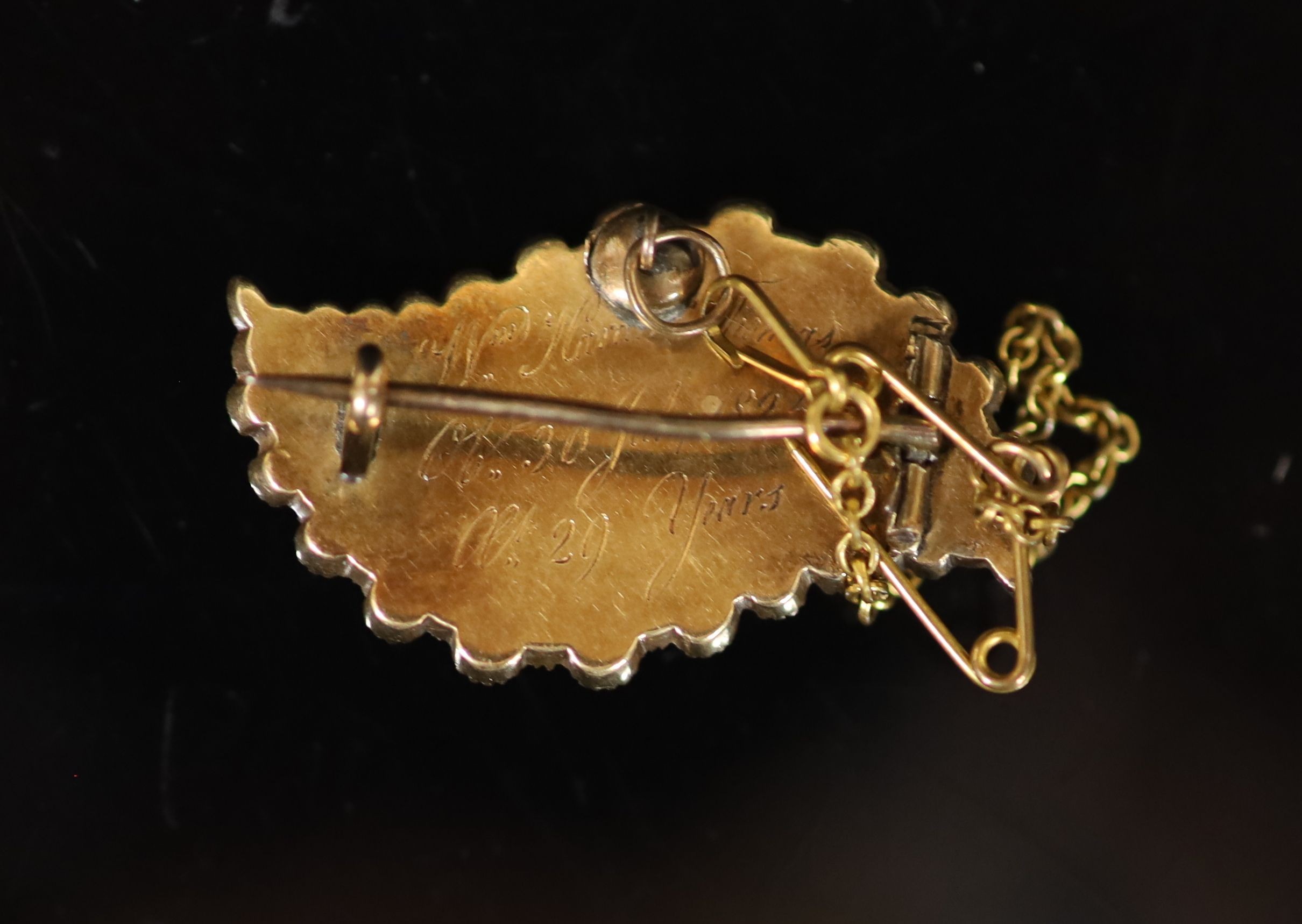 A George IV gold, graduated split pearl and black enamel leaf shaped mourning brooch